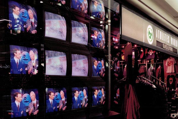Wall of televisions in a 1990s Athlete's World - past projects by Peter J's General Contracting
